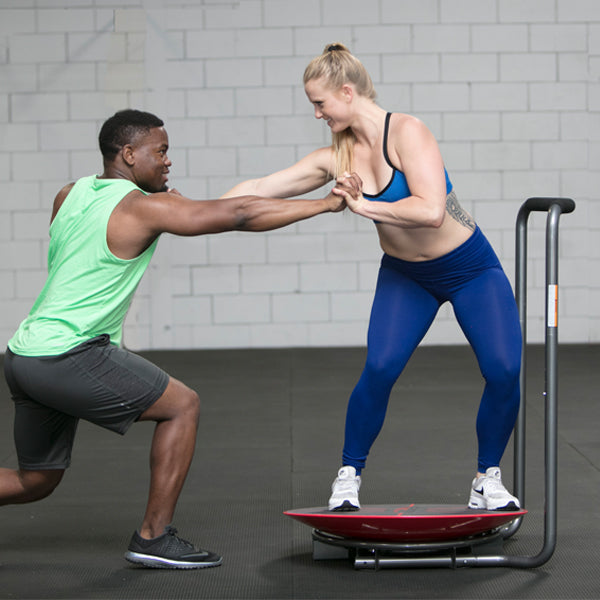 Man and women using Core-Tex Fitness Reactive Trainer to perform partner assisted exercise