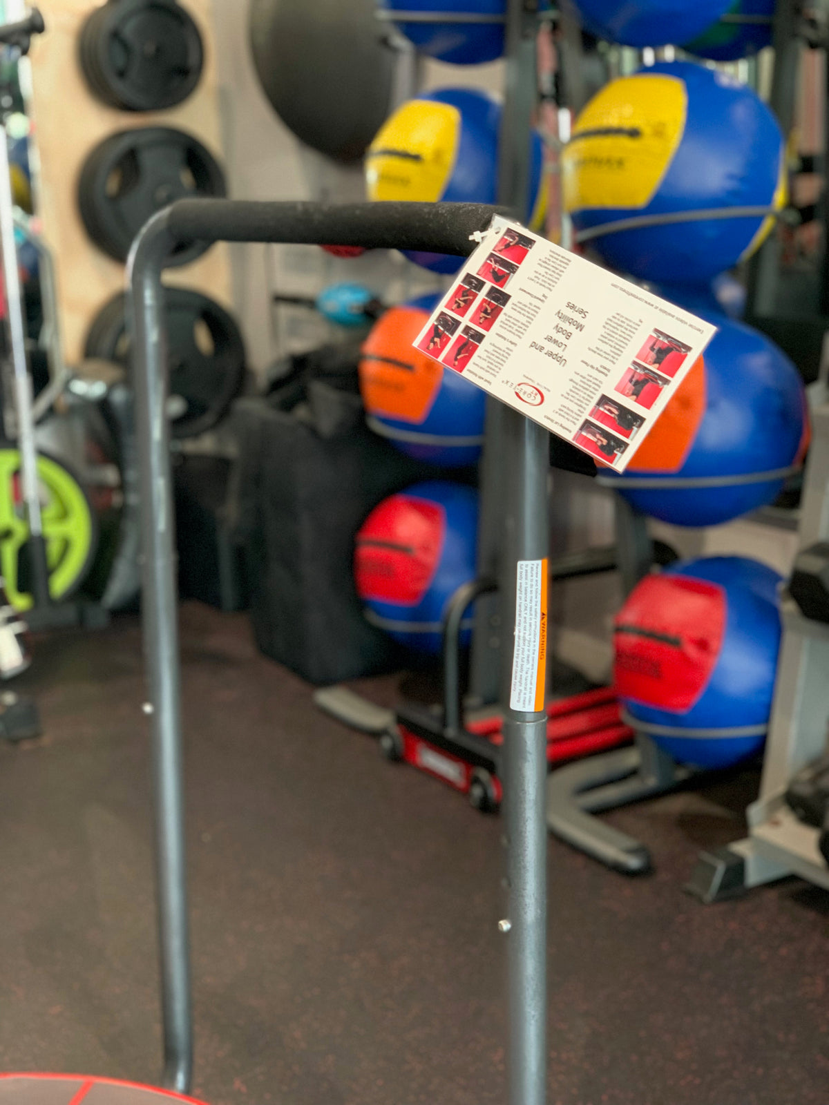 Core-Tex upper and lower body strength series card attached to Core-Tex Reactive Trainer handrail  