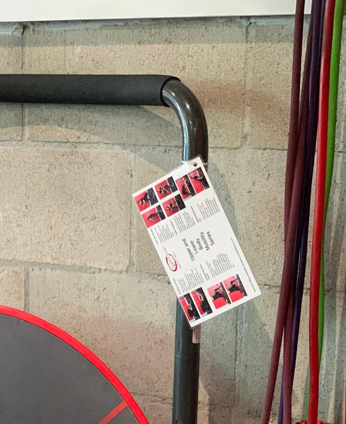 Red Core-Tex Reactive Trainer stored discreetly against wall next to weights and jump ropes 