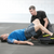 Physical therapist assists man doing an exercise on the Core-Tex Reactive Trainer