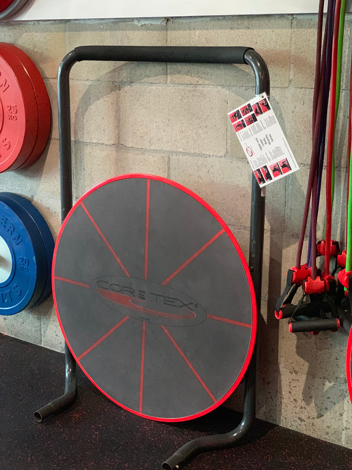 Red Core-Tex Reactive Trainer stored discreetly against wall next to weights and jump ropes 