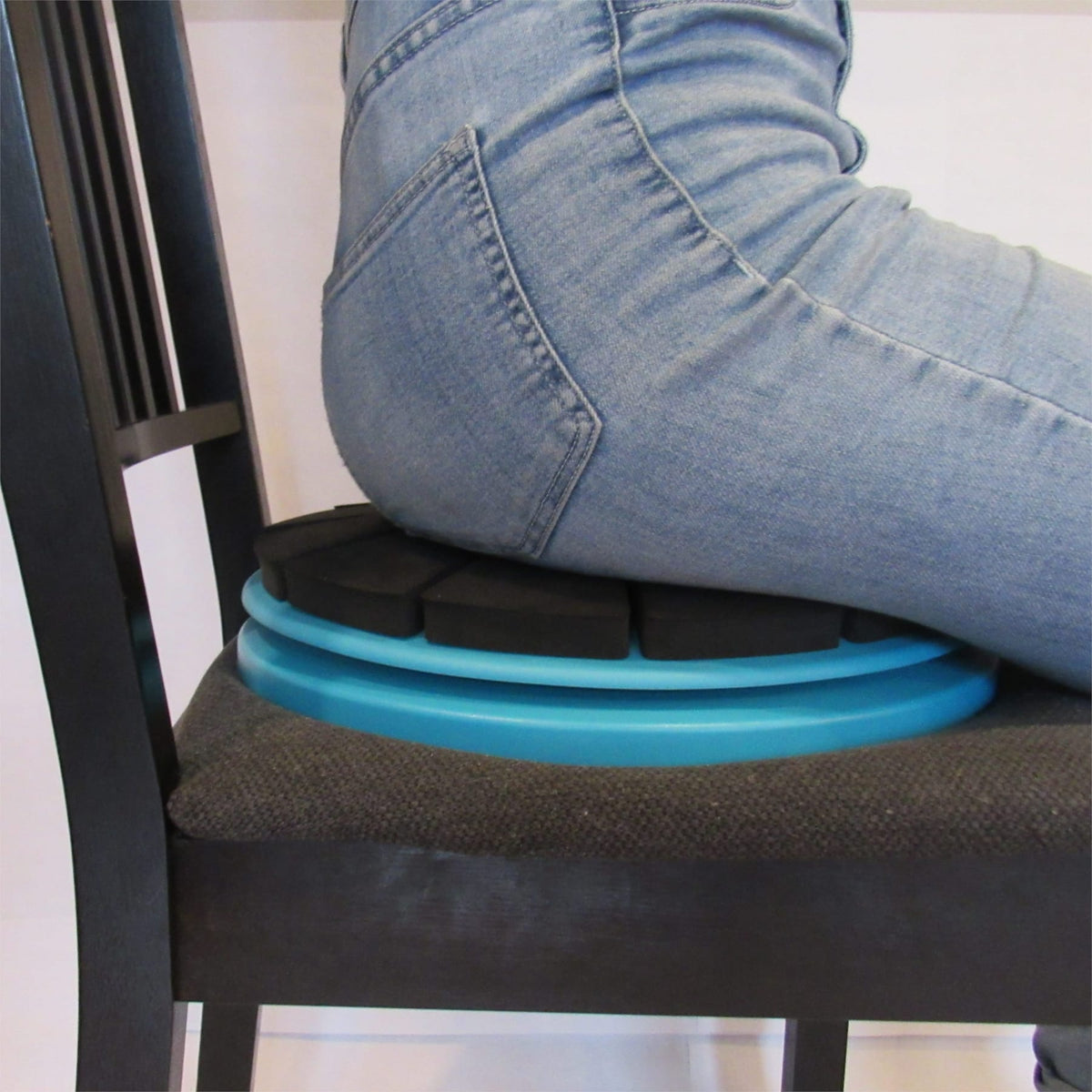 Close up of the Core-Tex Sit being used on at home chair by women in jeans.